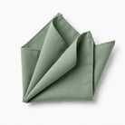 A folded green napkin is shown against a white background.