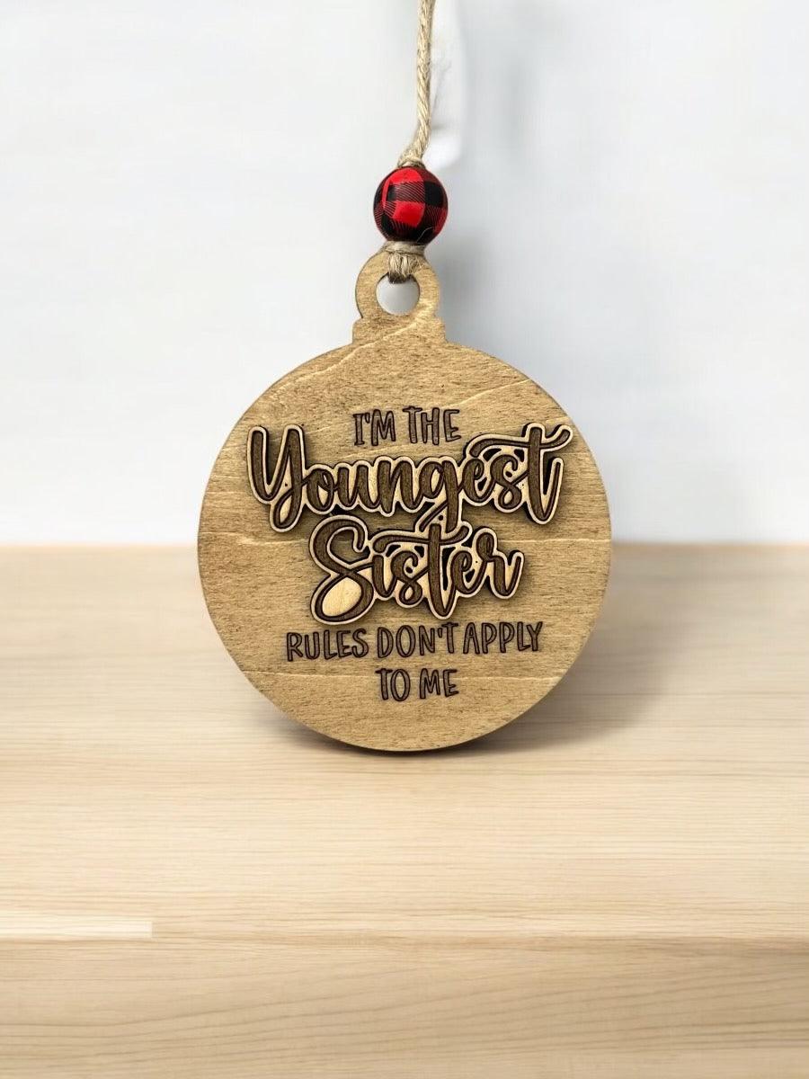 a wooden ornament that says, i'm the youngest sister rules don