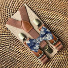 Size chart for suspender and bow tie sets from The Bold Bow Tie. X-Small (6mo-4yr): 15"-23" suspenders, 3.5" bow. Small (5-9yr): 18"-33" suspenders, 3.5" bow. Medium (10-12yr): 18"-33" suspenders, 4" bow. Adult (13yr-6'5"): 30"-53" suspenders, 4.5" bow. Big & Tall (Over 6'5"): 53"+ suspenders, 4.5" bow. Instructions note to measure from the back waistband over the shoulder to the front waistband for a comfortable fit.