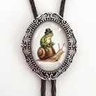 Bolo tie with frog and snail in silver and black leather cord.