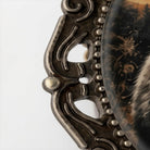 a close-up view of an ornate metal frame with a decorative design.