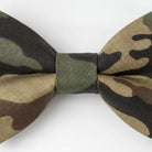 A camouflage bow tie with a dark green and beige pattern.