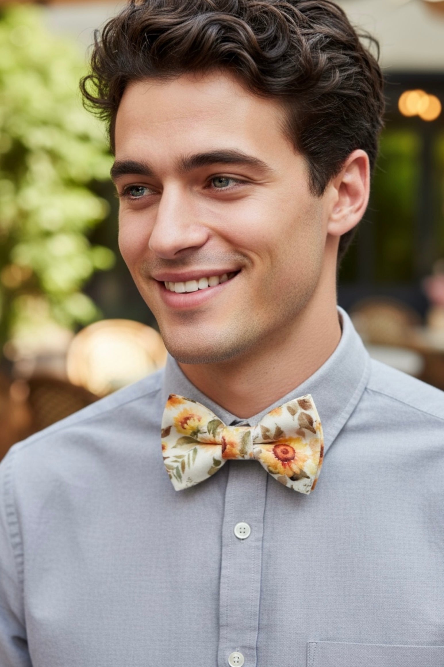 Groomsman wearing a wild sunflower bow tie with a gray shirt
