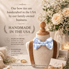 The image is an advertisement for handmade bow ties, featuring a mannequin wearing a blue and white floral bow tie, surrounded by wedding decorations and flowers.