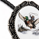 A decorative oval-shaped frame with a metal frame and a painting of a man riding a duck on a lasso.