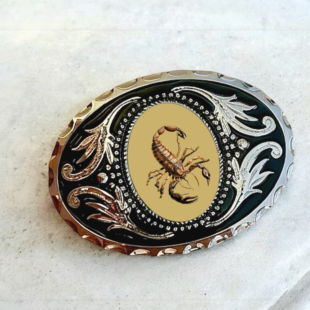 Belt buckle with scorpion on a silver belt.