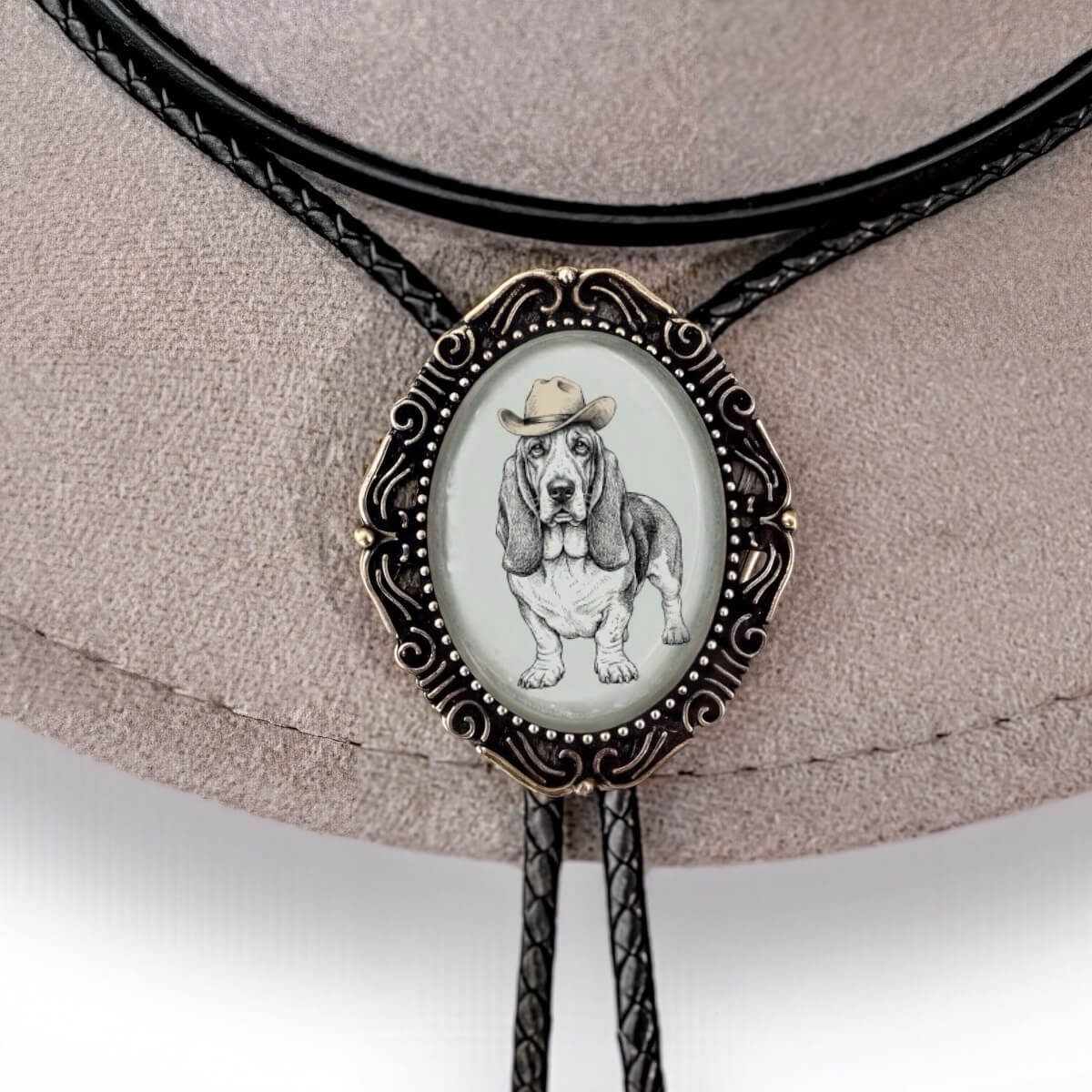 Dog bolo tie with cowboy had hanging on leather cord.
