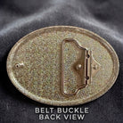 a close-up view of a shiny, metallic belt buckle with a textured surface.