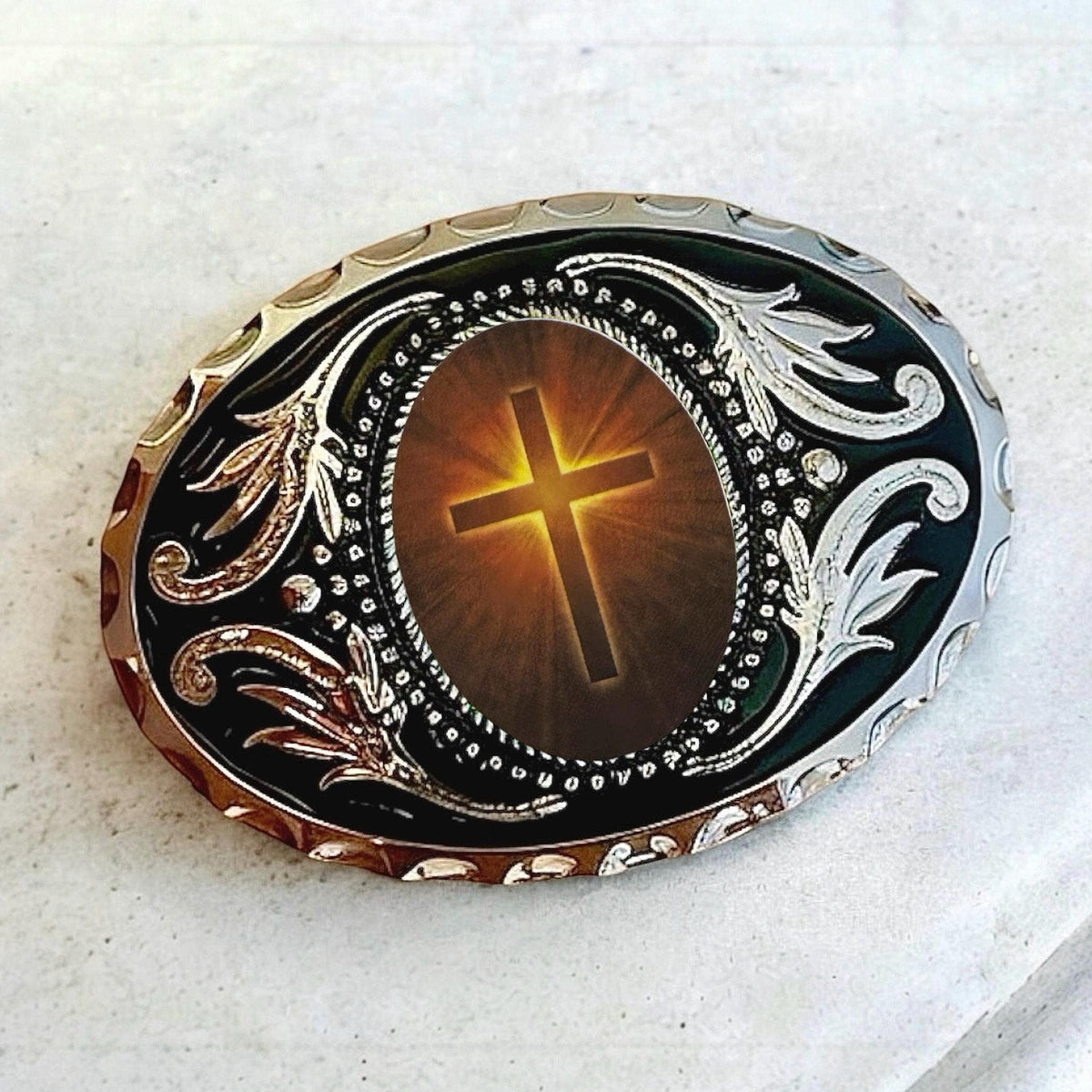 a decorative oval-shaped object with a cross design on it.