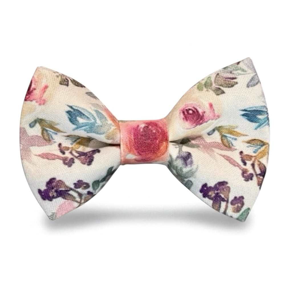 Pre-tied watercolor floral bow tie with pink roses and purple flowers on a light cream background.