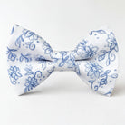 A white and blue floral mens bow tie with a blue floral pattern.