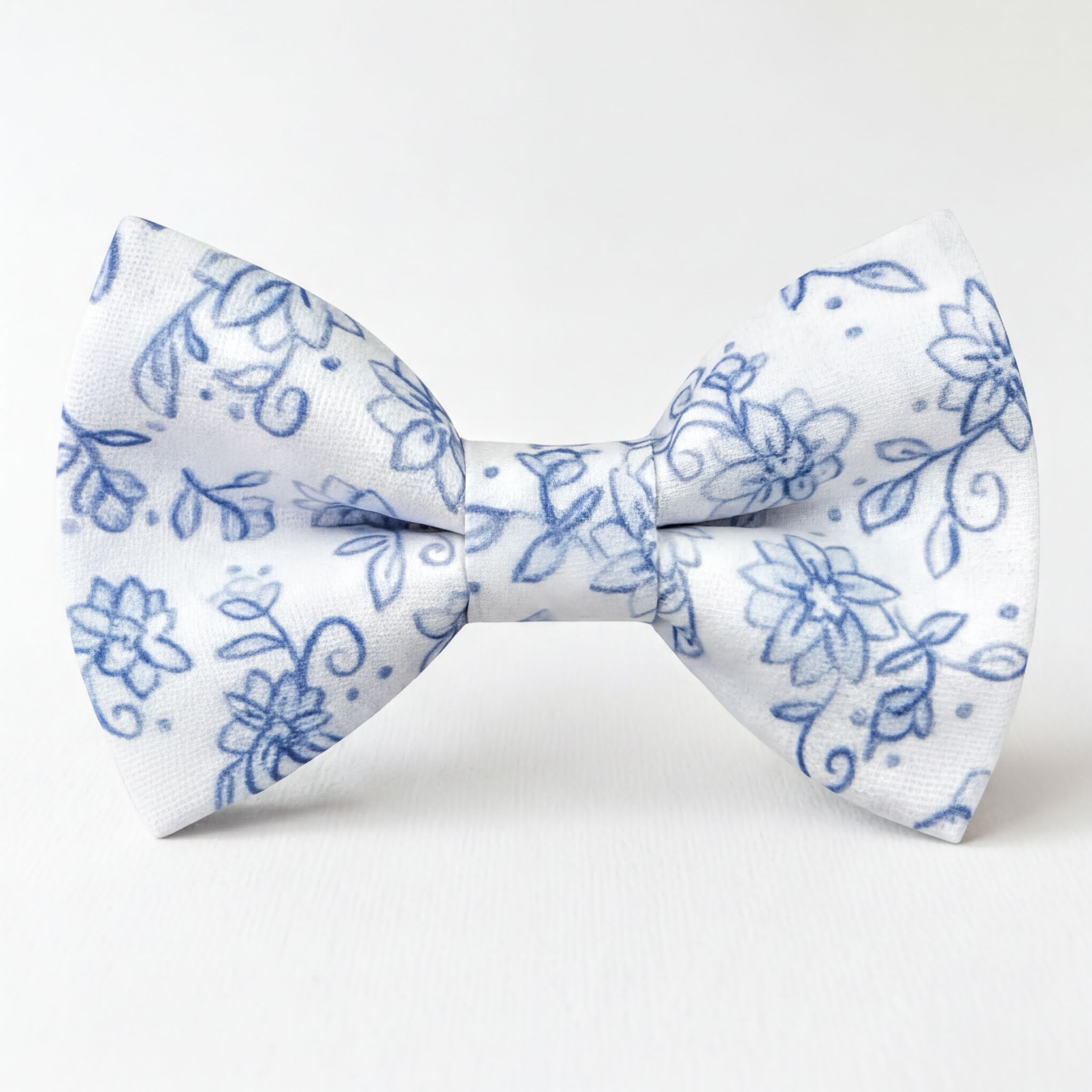 A white and blue floral mens bow tie with a blue floral pattern.