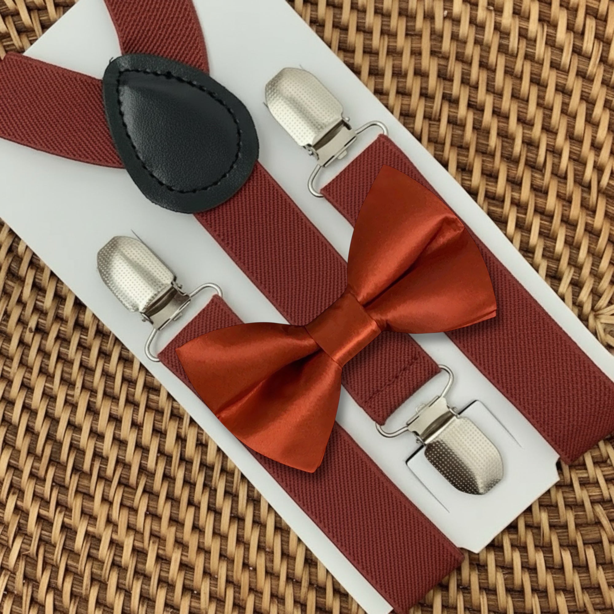 Burnt orange bow tie and terracotta suspenders for a wedding, groomsmen, or ring bearer outfit.