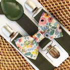 Floral bow tie and suspenders set for a wedding, groomsmen or ring bearer on a woven surface