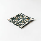 A square-shaped handkerchief with a floral pattern in shades of green and white.