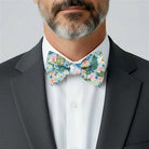 Size chart for pre-tied bow ties from The Bold Bow Tie detailing measurements across three sizes. Small is 3.5 inches wide and recommended for ages 6 months to 5 years. Medium is 4 inches wide and recommended for ages 6 to 12 years. Large is 4.5 inches wide and recommended for ages 13 years and up. Visual icons illustrate the relative sizes with horizontal arrows showing that width is measured from wingtip to wingtip. Bottom text notes that all bow ties are pre-tied and ready to add to your outfit.