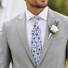 Groomsman in a blue floral tie and gray suit.