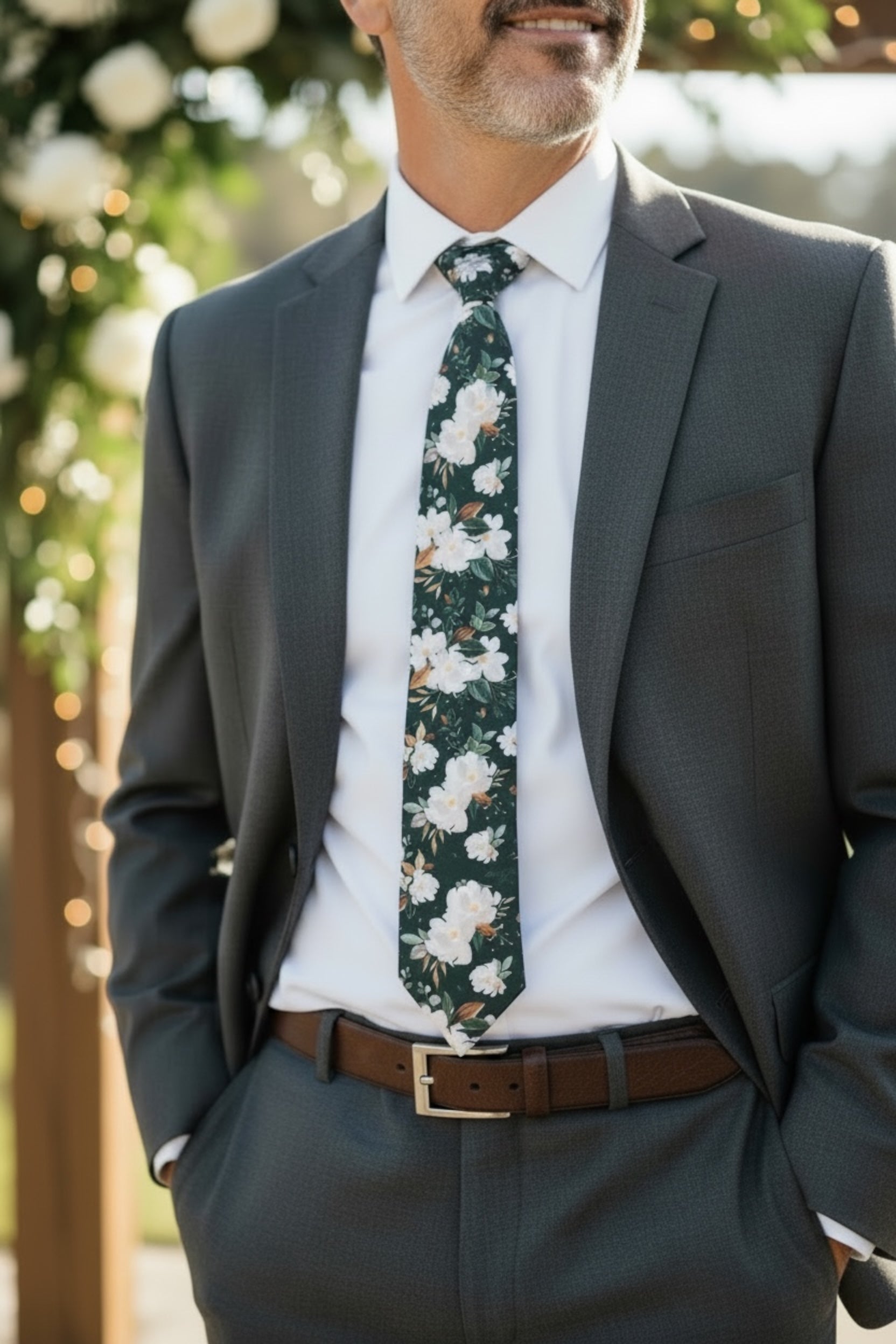 Emerald floral mens tie worn by a groomsman at a wedding.