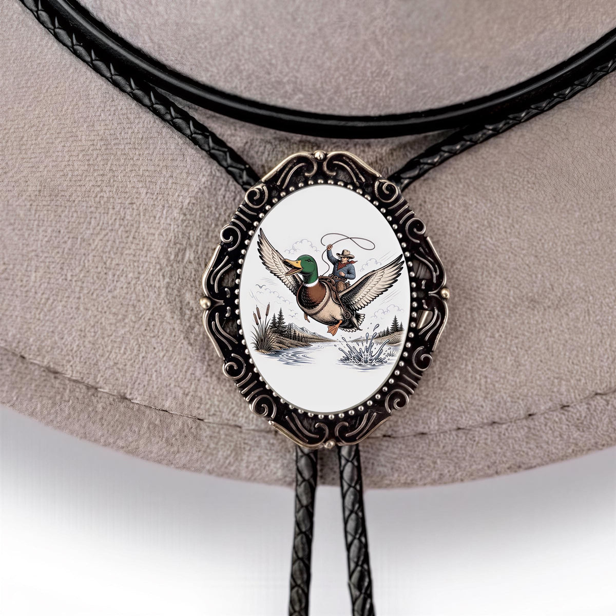 A decorative bibelow tie with a metal frame featuring a detailed illustration of a duck in flight.