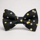 Black bow tie with gold and silver polka dots on a white background