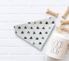 Gray boho heart bandana with black hearts on a white surface with dog treats and a 'Good Dog' mug.