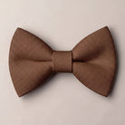 Solid chocolate brown formal groomsmen bow tie isolated on a white background