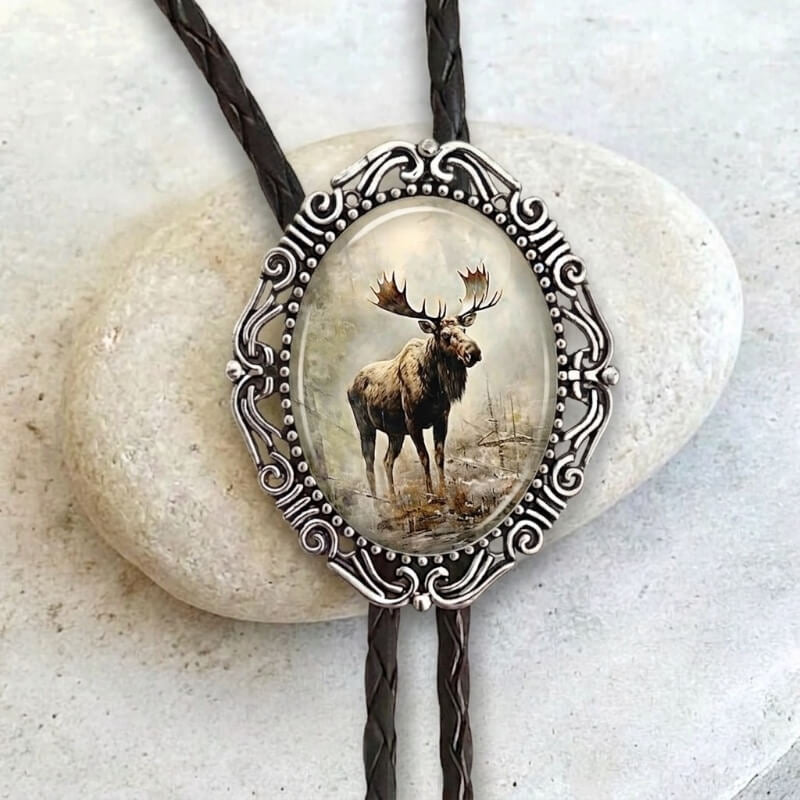 Bolo tie with moose in silver with leather cord.