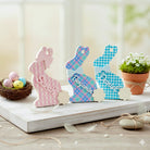Colorful acrylic Easter basket for tags with bunny decorations with names on a wooden surface with a blurred background