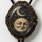 a pendant with a moon and stars design, encased in an ornate, decorative frame.