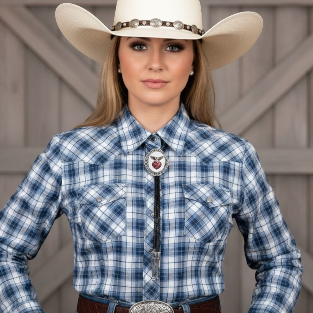 Woman wearing a Valentine’s Day bolo tie for women and a blue plaid shirt with a large cowboy hat and a belt buckle.