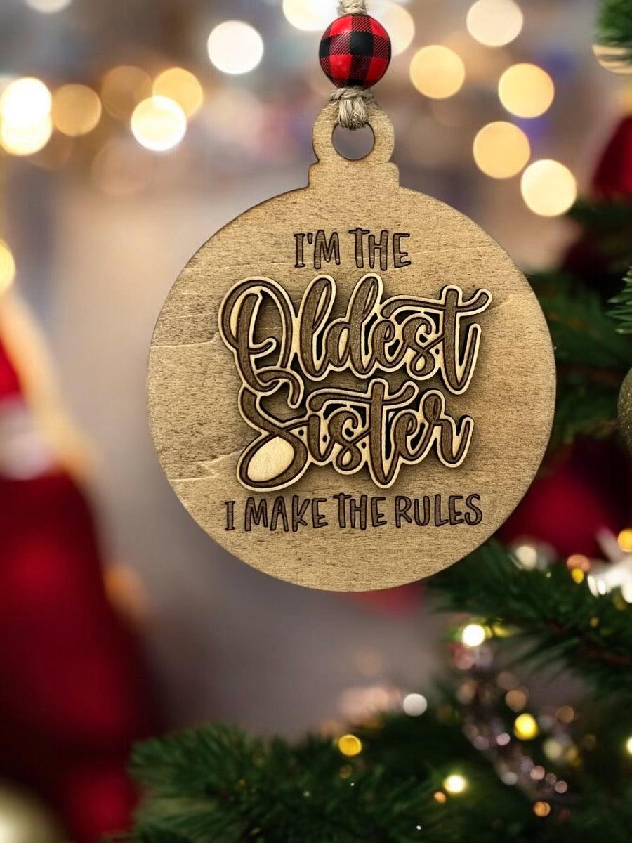 a wooden ornament that says i'm the oldest sister i make the