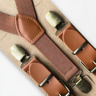 Brown men’s suspenders with bronze clips.