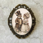 Decorative Easter bunny brooch pin with rabbits in formal attire on a marble background