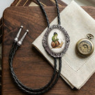 Bolo tie on a desk with frog and snail bolo ties.