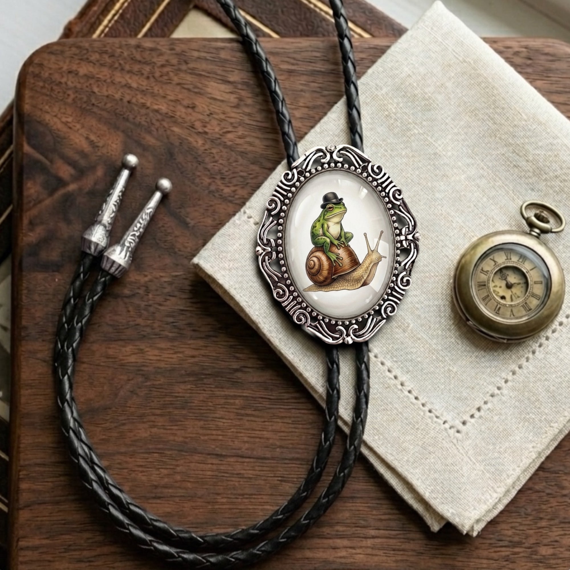 Bolo tie on a desk with frog and snail bolo ties.