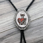 Bolo tie with skeleton and heart design for Valentine’s Day on a wooden surface