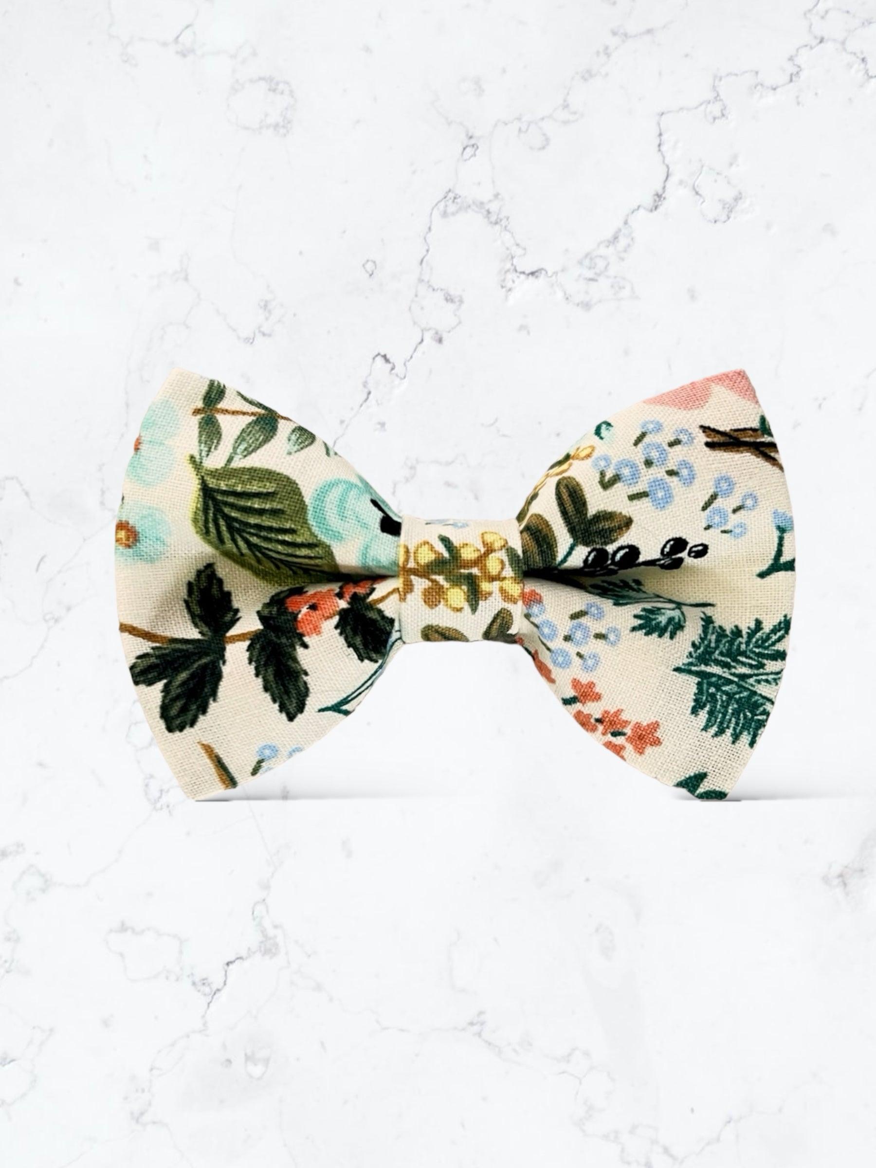 Ivory Floral Bow Tie- Made with Rifle Paper Co fabric, Mens Wedding Bowtie for groomsmen, ring bearers and groom against a marble background.