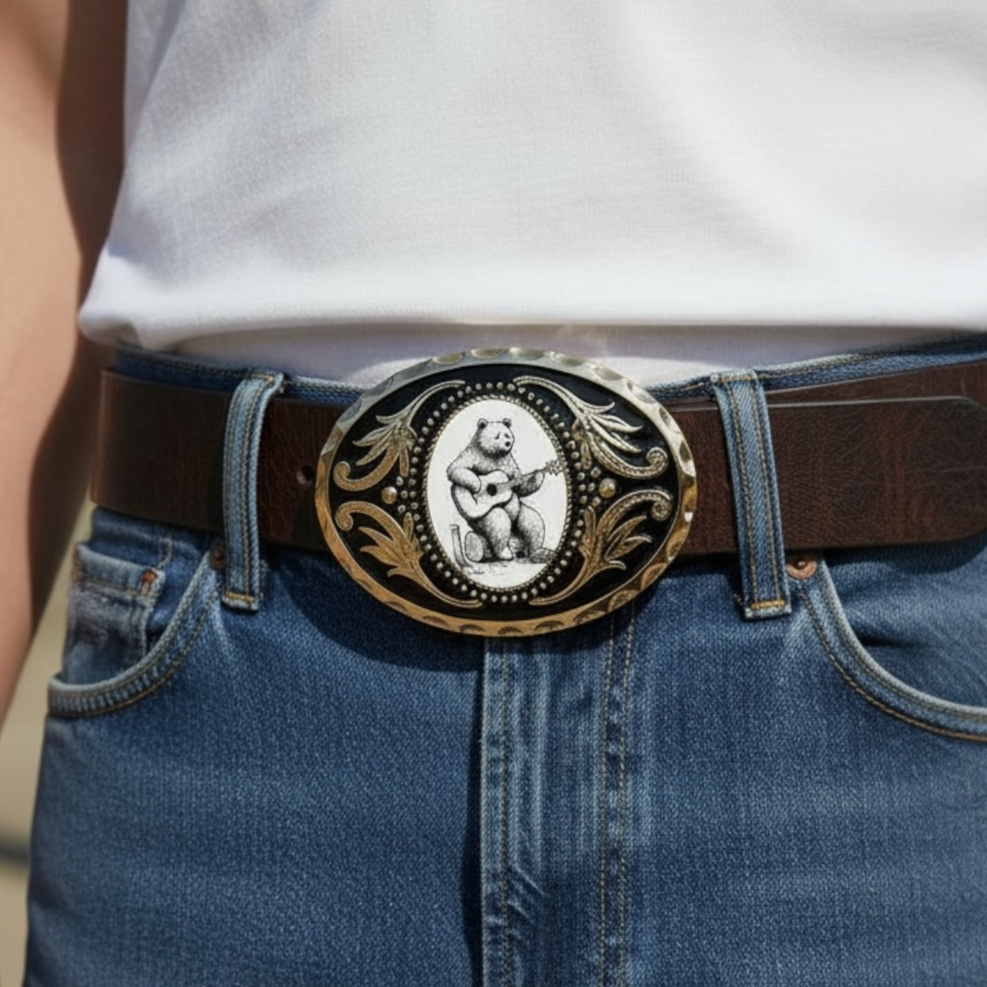 Bear belt buckle featuring a bear playing guitar on blue jeans.