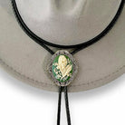 Bolo tie with green lily of the valley may flower design on a hat