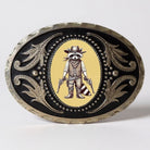 Decorative raccoon belt buckle with guns in cowboy attire on a yellow background