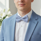 Man wearing a navy blue seersucker bow tie for Easter with a white shirt.