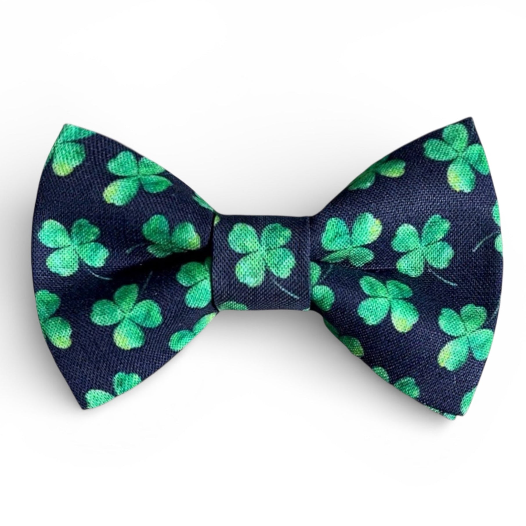 Navy blue bow tie with green shamrock pattern on a white background