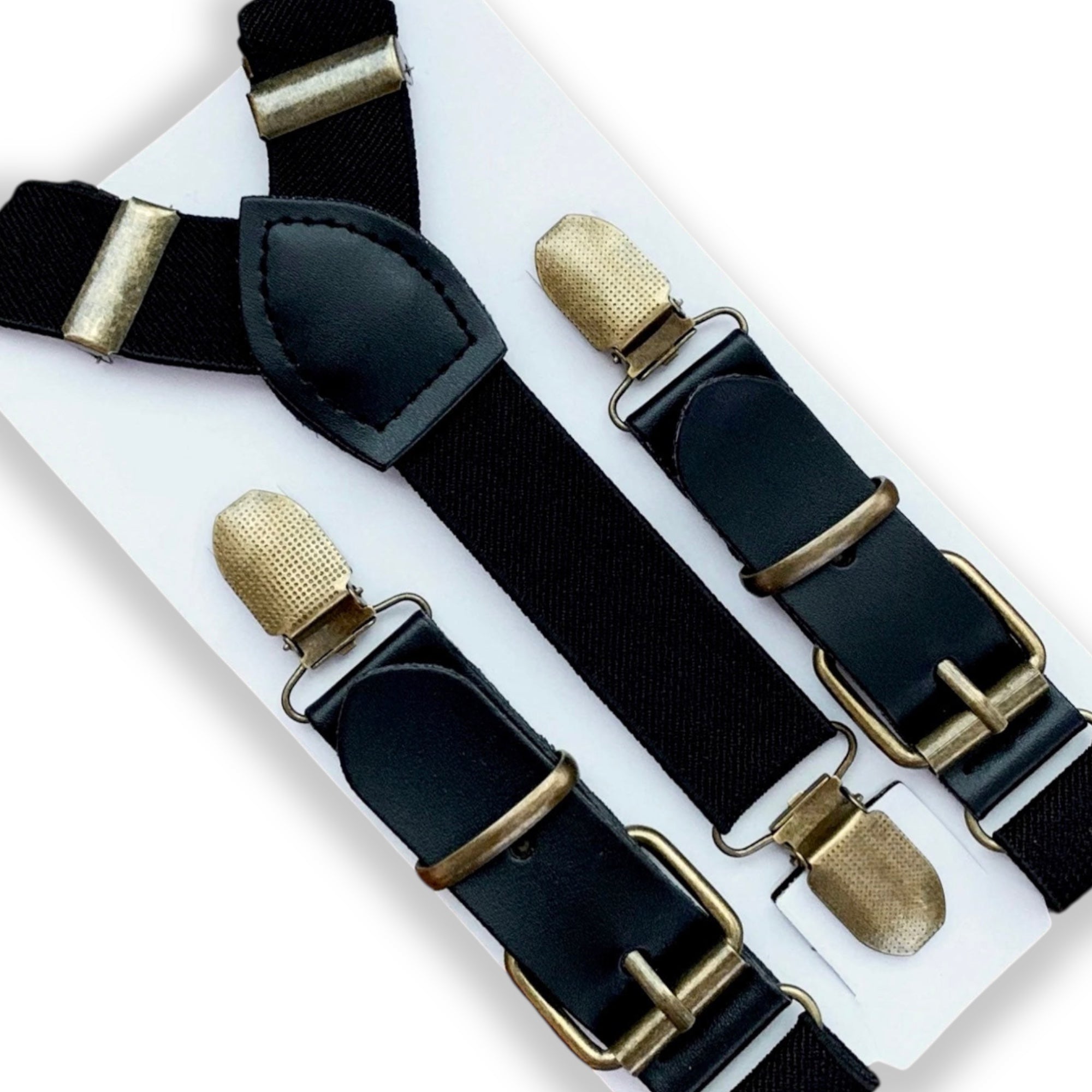 Black suspenders with brass clips on a white background for groomsmen, ring bearers and wedding guests.