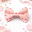 Pink bow tie with heart patterns on a light background