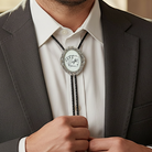 Man wearing a suit with a decorative cards bolo tie featuring playing card symbols.