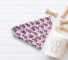 Valentines Day dog bandana with gnomes on a white surface with dog treats and a 'Good Dog' mug.