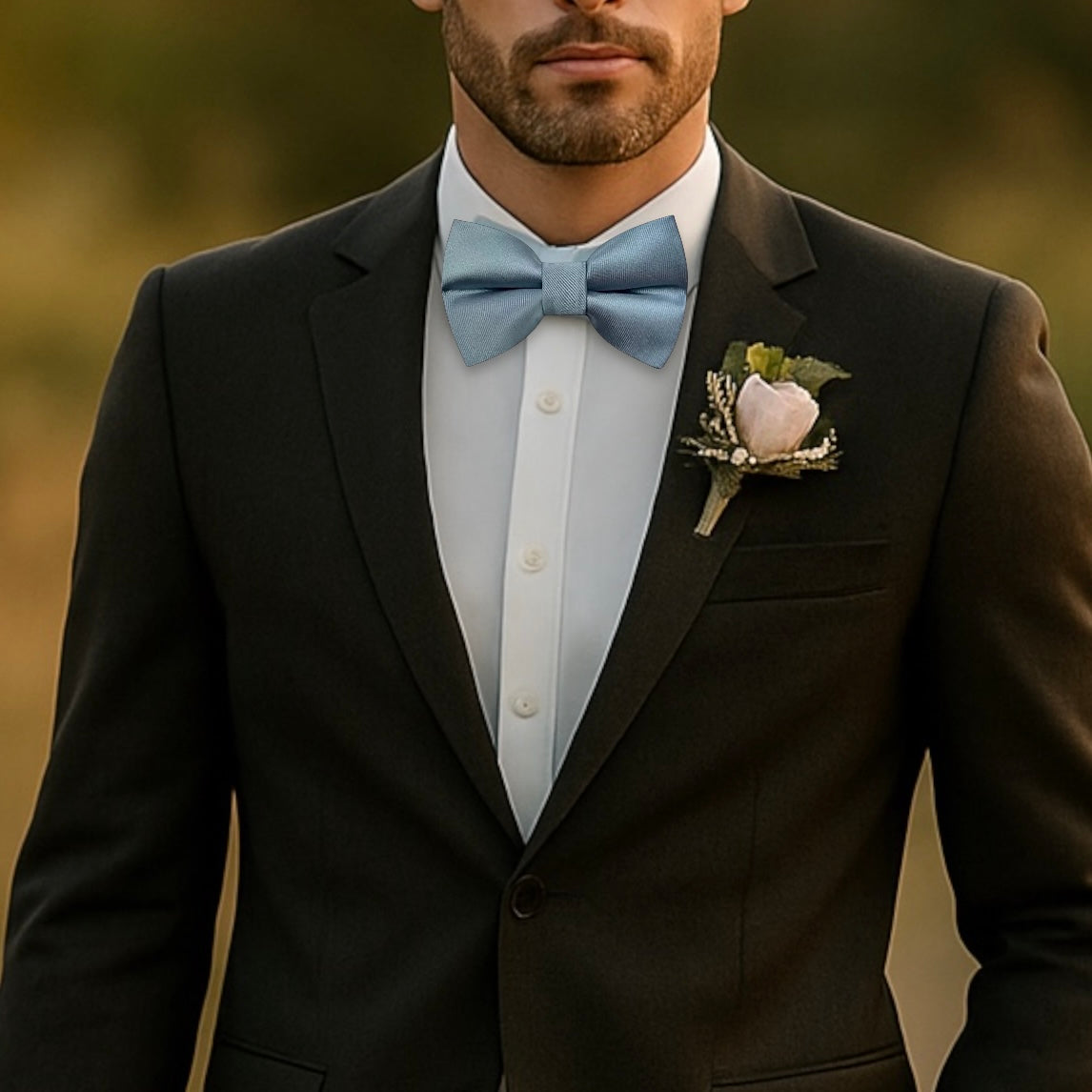 Dusty blue bow tie worn by a groomsman at a wedding.
