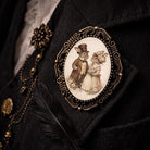 Decorative brooch with Easter bunnies with a couple design on a dark academia background