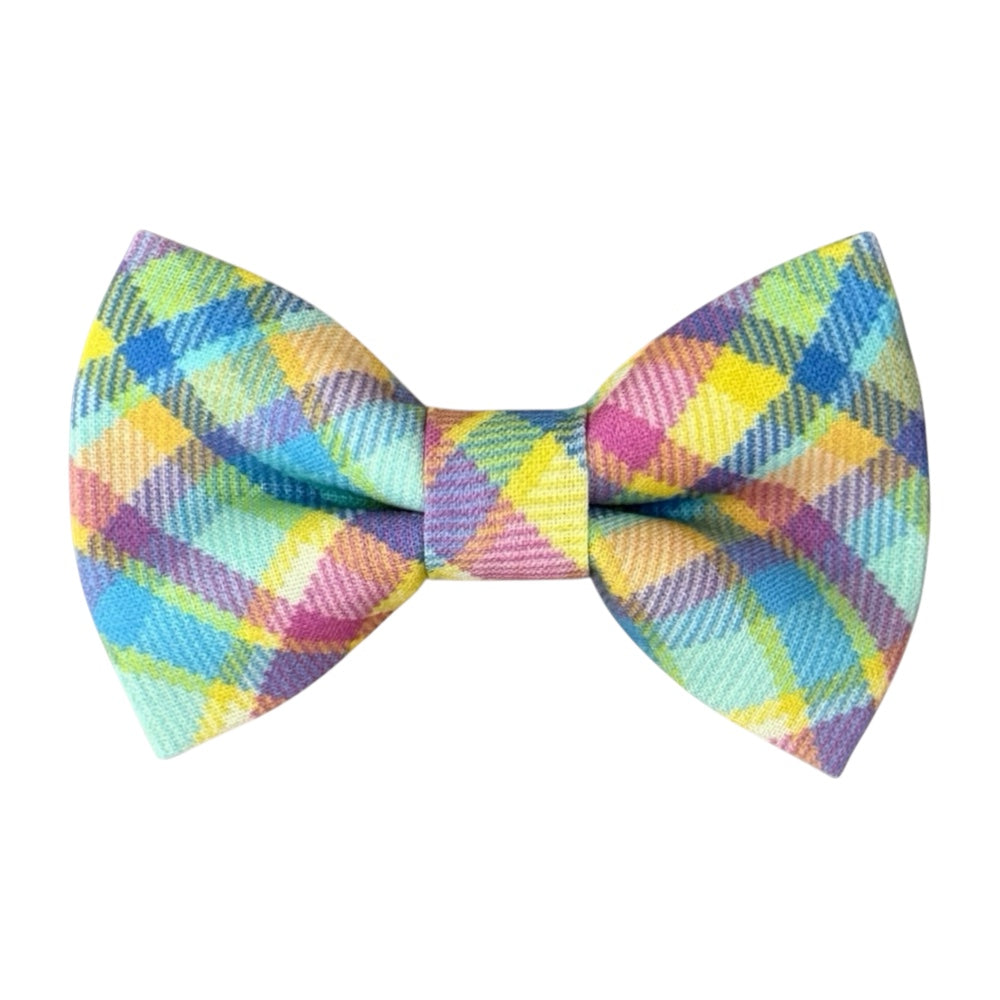 Front view of a pre-tied colorful Madras plaid bow tie featuring a vibrant multi-color check pattern in shades of blue, orange, green, and yellow.