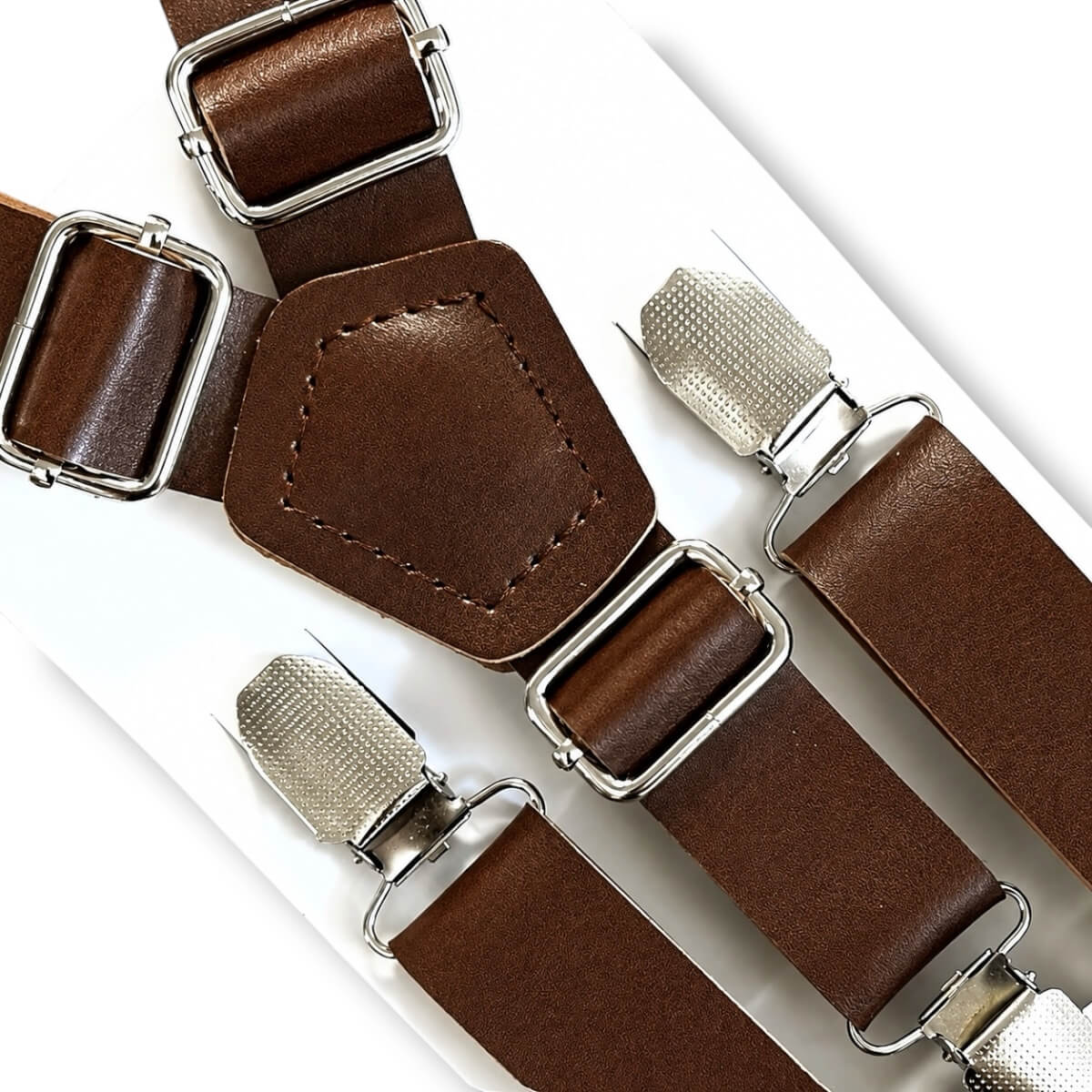 Brown leather suspenders for men boys toddlers and babies with silver metal clips and buckles, arranged diagonally on a white background.